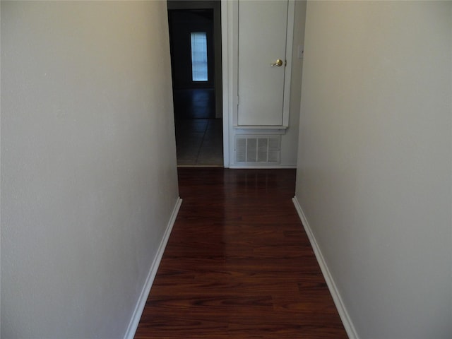 corridor with dark wood-type flooring