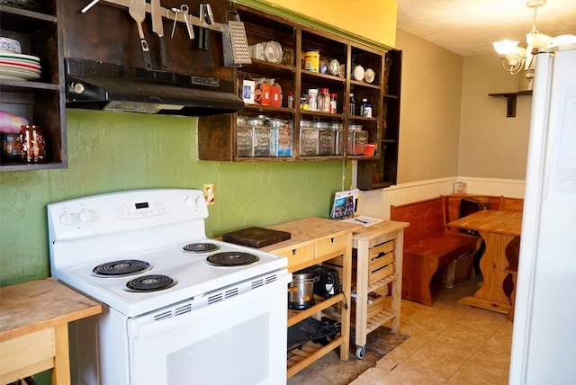 kitchen with an inviting chandelier, light tile patterned floors, pendant lighting, and electric stove