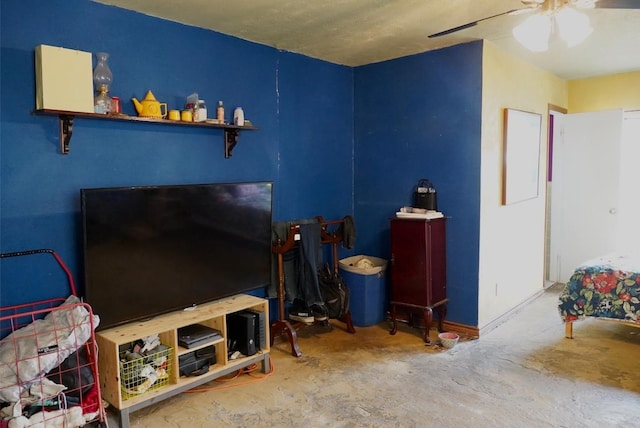 living room with ceiling fan and concrete flooring