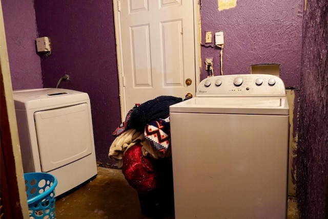 clothes washing area with washer and clothes dryer