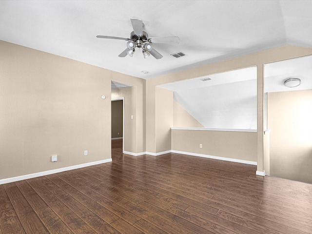 empty room with dark wood-type flooring, ceiling fan, and lofted ceiling