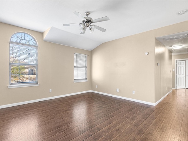 empty room featuring ceiling fan, dark hardwood / wood-style flooring, and lofted ceiling