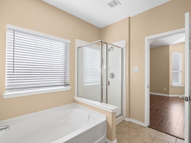 bathroom featuring tile patterned floors and plus walk in shower