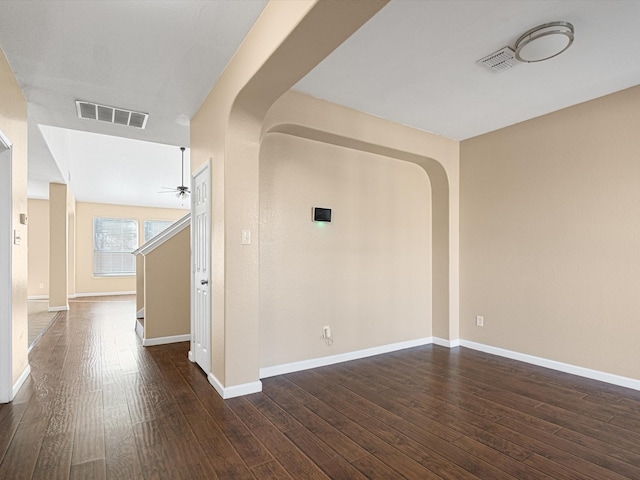 spare room featuring ceiling fan and dark hardwood / wood-style flooring