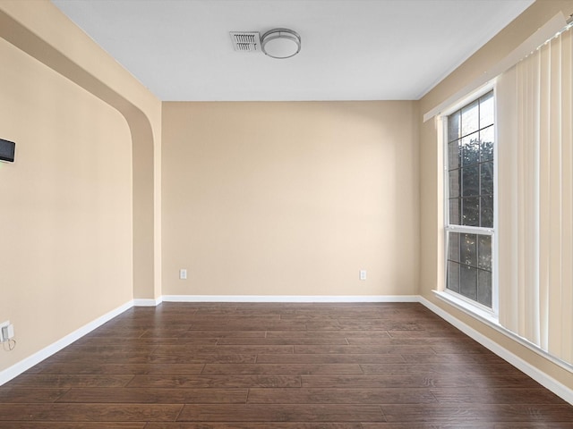 unfurnished room featuring dark hardwood / wood-style flooring