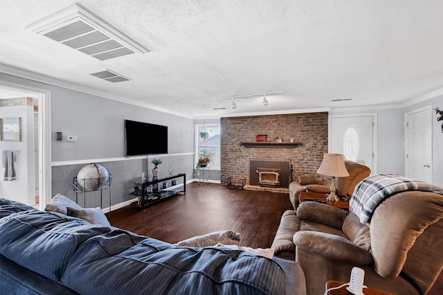 living room with rail lighting, ornamental molding, dark hardwood / wood-style flooring, and a textured ceiling