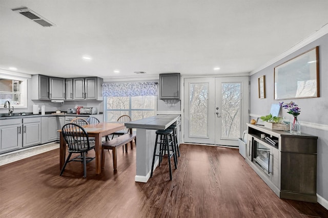 kitchen featuring a wealth of natural light, decorative backsplash, and gray cabinets