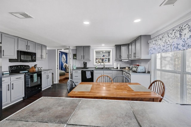 kitchen featuring sink, black appliances, and gray cabinetry