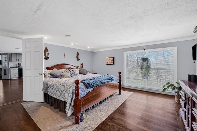 bedroom with a textured ceiling, dark hardwood / wood-style floors, and ornamental molding