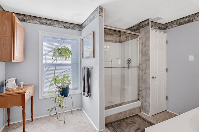 bathroom with a shower with door