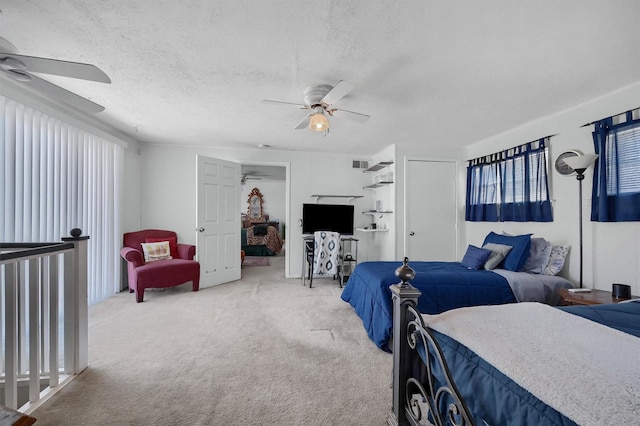 carpeted bedroom featuring a textured ceiling and ceiling fan