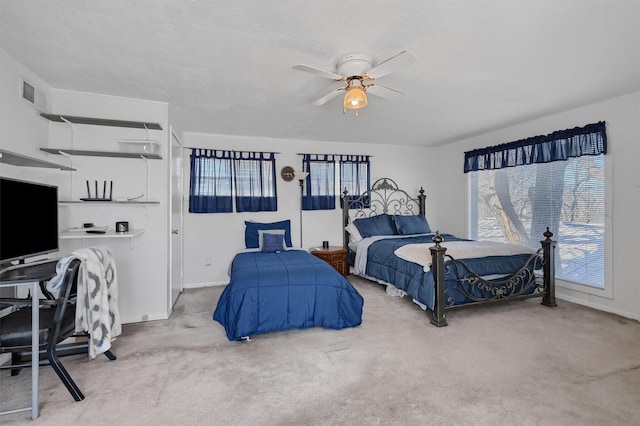 bedroom featuring ceiling fan and light carpet