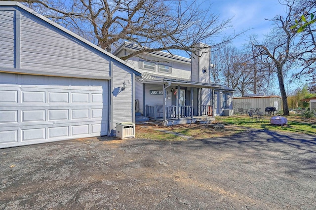 view of front of home with a porch and a garage