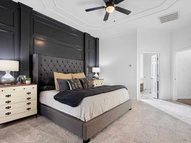 carpeted bedroom with ceiling fan, connected bathroom, and ornamental molding