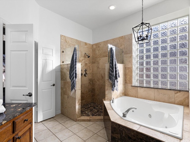 bathroom featuring plus walk in shower, a chandelier, tile patterned floors, and vanity