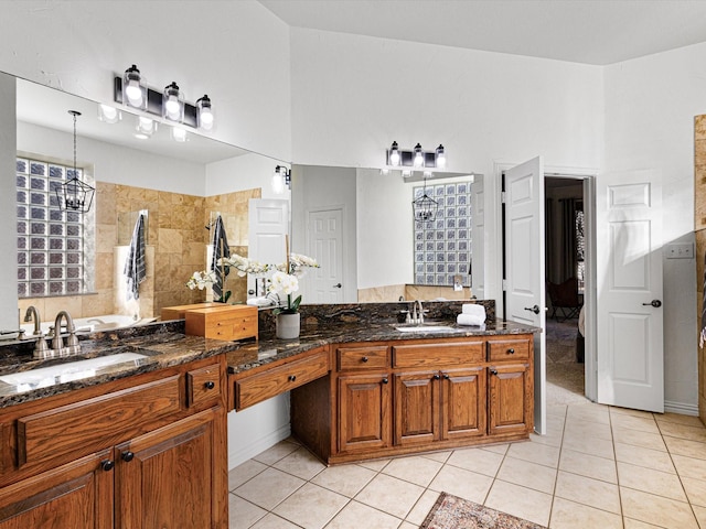 bathroom featuring vanity, a notable chandelier, and tile patterned floors