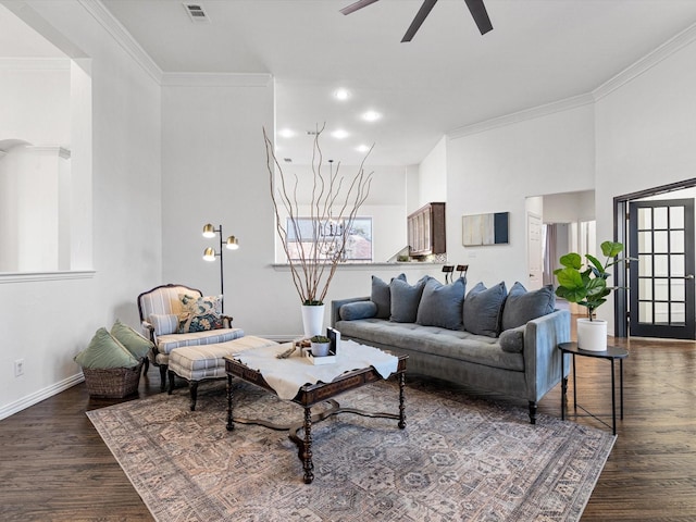 living room with ceiling fan, dark hardwood / wood-style flooring, and crown molding