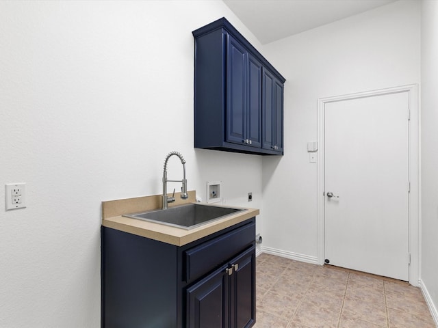 kitchen with light tile patterned flooring, sink, and blue cabinets