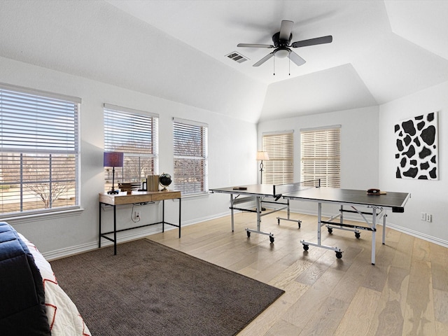 recreation room with ceiling fan, light wood-type flooring, and lofted ceiling