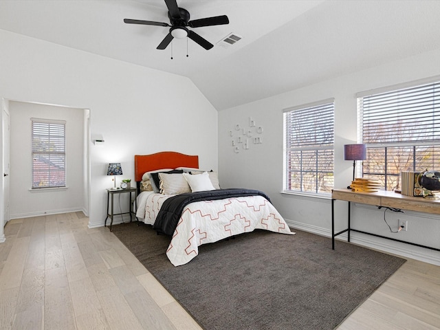 bedroom featuring ceiling fan, vaulted ceiling, and light wood-type flooring