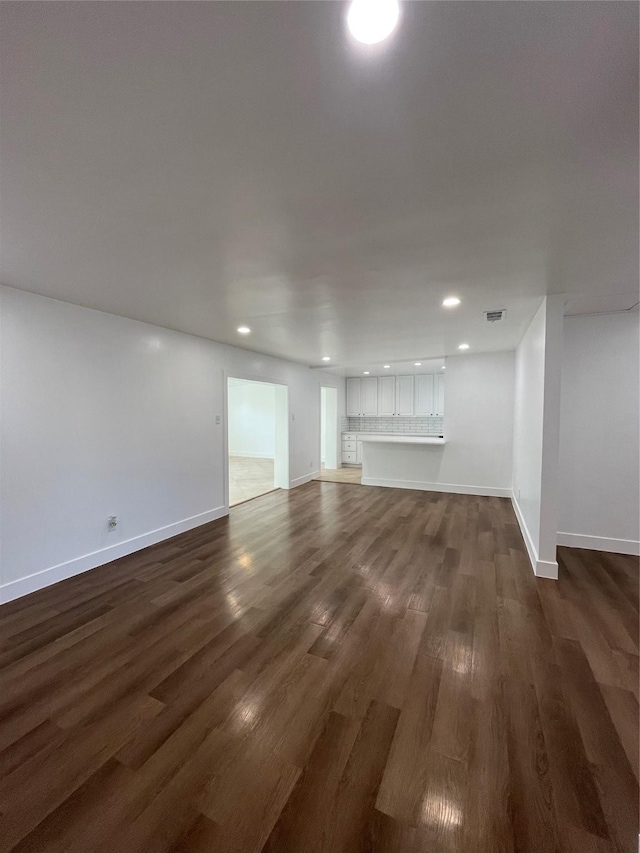 unfurnished living room featuring dark hardwood / wood-style floors