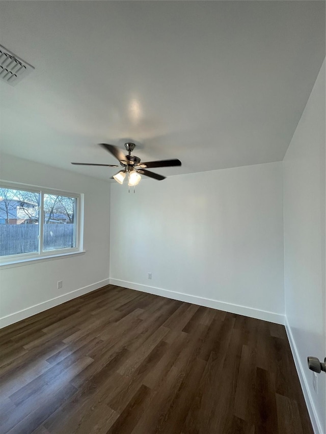 empty room with ceiling fan and dark wood-type flooring