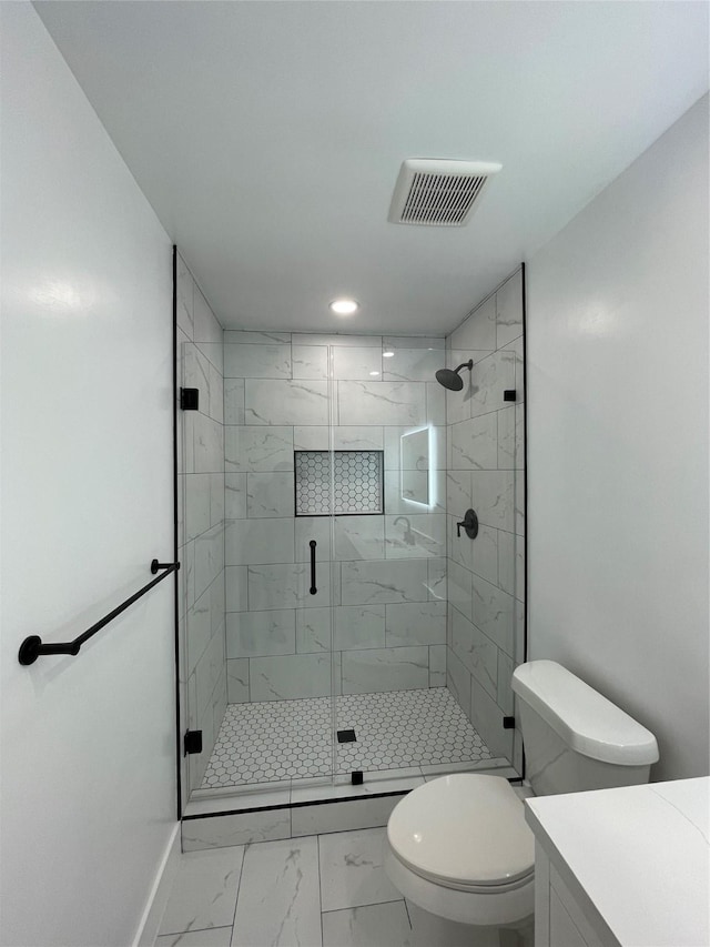 bathroom with toilet, an enclosed shower, and vanity