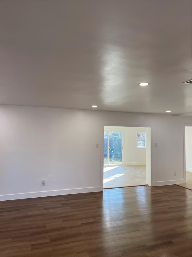 spare room featuring dark wood-type flooring