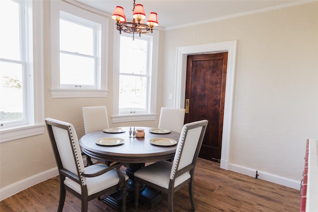 dining space featuring radiator, dark hardwood / wood-style flooring, ornamental molding, and an inviting chandelier