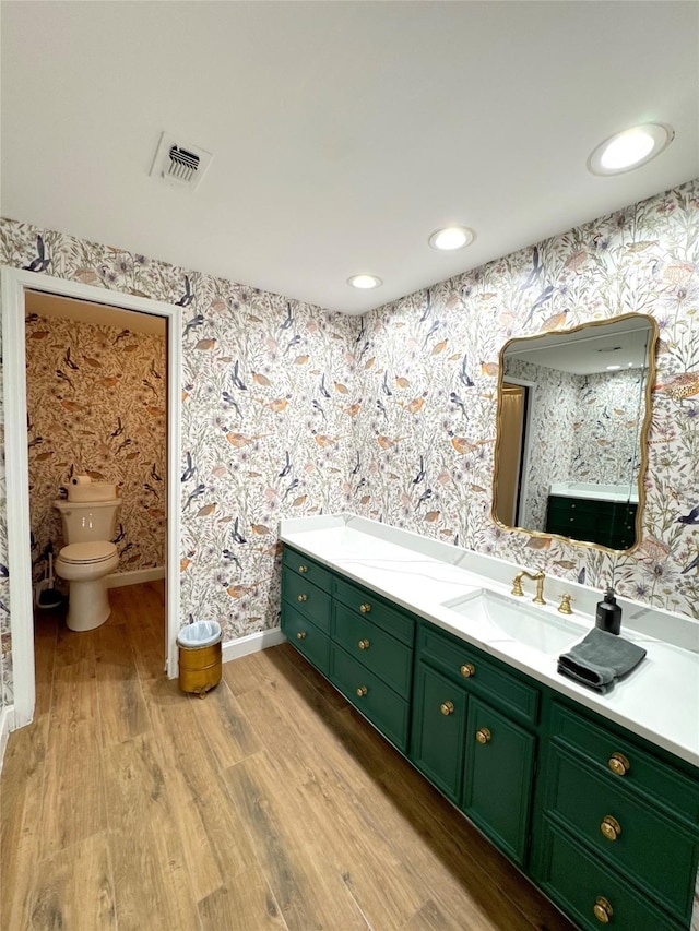 bathroom featuring hardwood / wood-style floors, toilet, and vanity