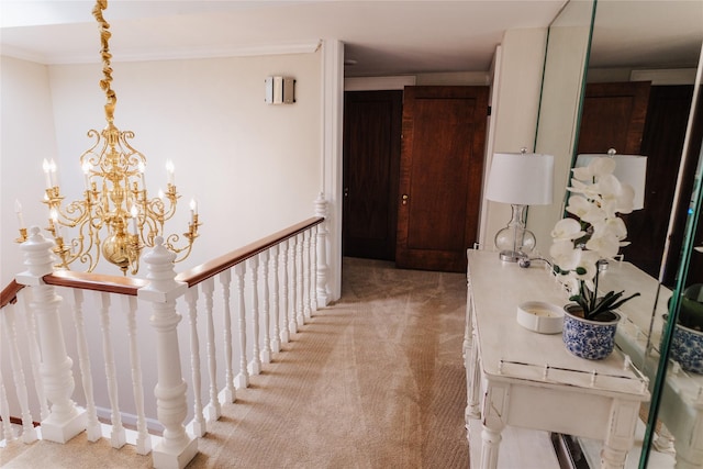 hall featuring light colored carpet, a chandelier, and ornamental molding