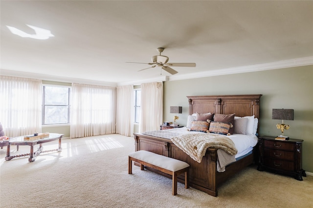 carpeted bedroom with ceiling fan and ornamental molding