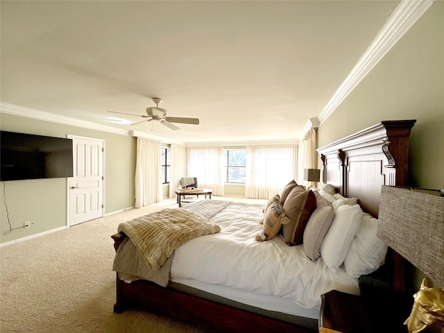 carpeted bedroom featuring ceiling fan and crown molding