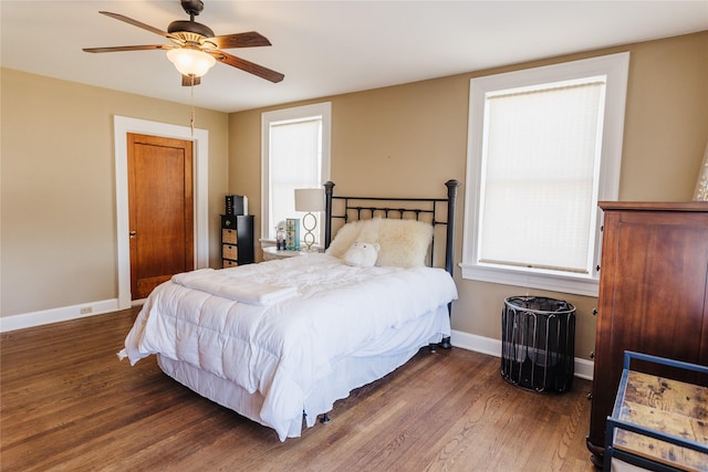 bedroom with ceiling fan and dark hardwood / wood-style flooring