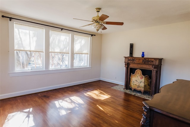 unfurnished living room with ceiling fan and dark hardwood / wood-style flooring