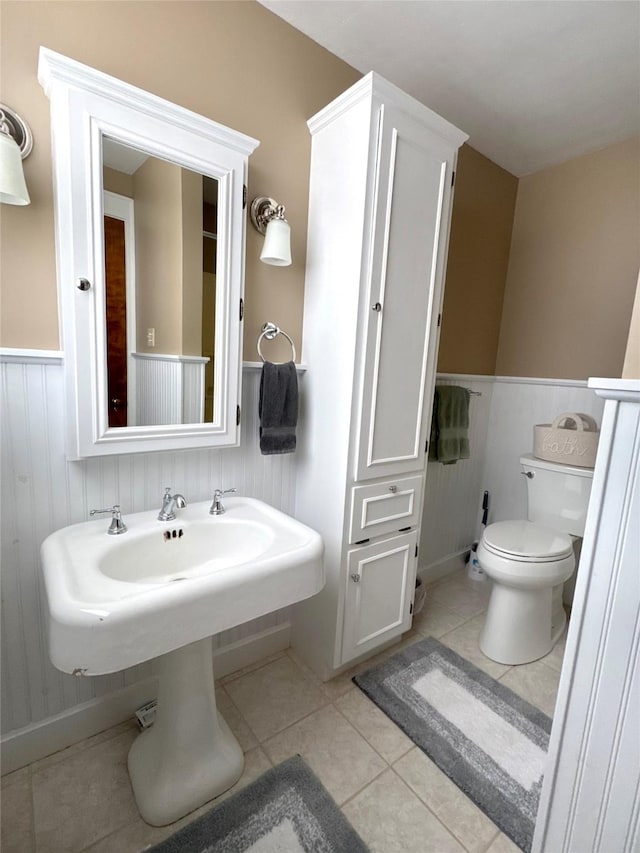 bathroom with toilet and tile patterned flooring