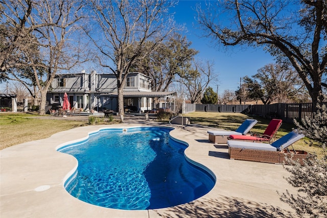 view of pool with a patio area and a yard