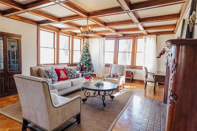 living room with beam ceiling, a healthy amount of sunlight, a chandelier, and coffered ceiling