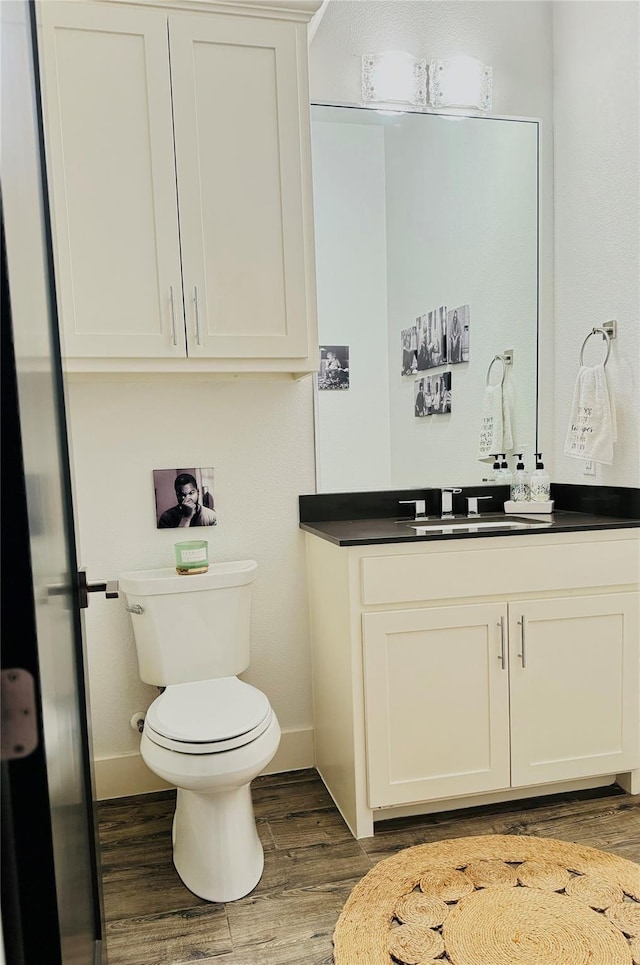 bathroom featuring hardwood / wood-style floors, toilet, and vanity