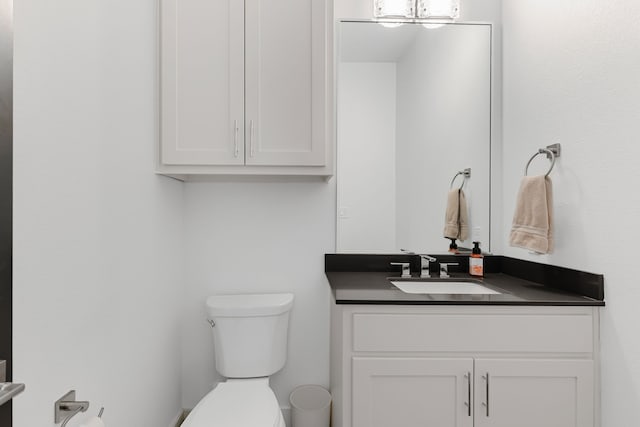 bathroom featuring toilet and vanity