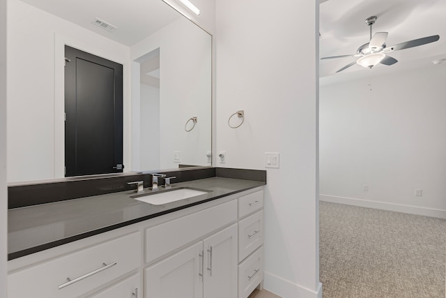 bathroom featuring visible vents, baseboards, a ceiling fan, and vanity