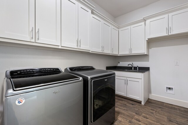 clothes washing area with dark wood-style floors, baseboards, cabinet space, separate washer and dryer, and a sink