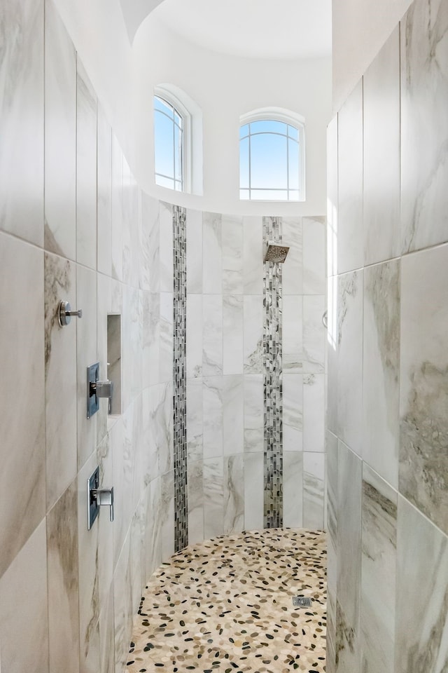 full bath with a tile shower