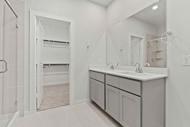 bathroom with vanity, a shower with shower door, and tile patterned flooring