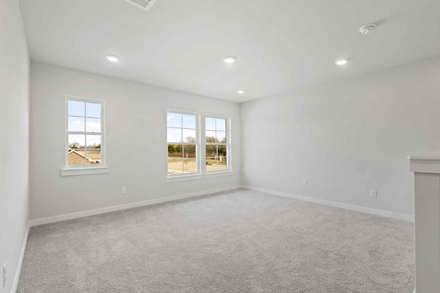 carpeted spare room with a wealth of natural light