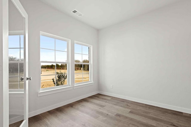 empty room with wood-type flooring