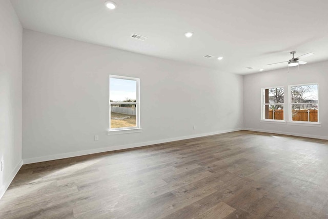 unfurnished room featuring hardwood / wood-style floors, plenty of natural light, and ceiling fan