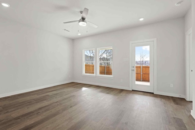 spare room with hardwood / wood-style flooring and ceiling fan