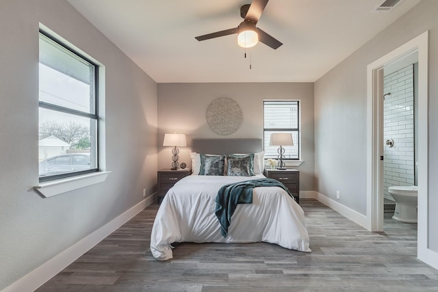 bedroom with ensuite bathroom, ceiling fan, and hardwood / wood-style flooring