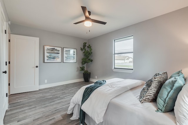 bedroom with ceiling fan and light hardwood / wood-style flooring